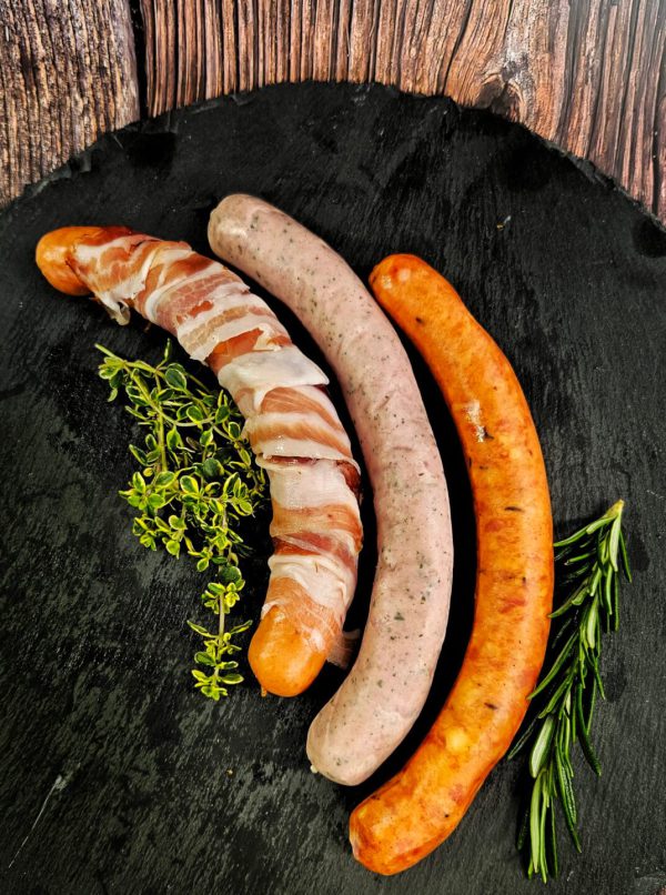 Drei Lungauer Würste mit Kräutern auf Schieferplatte, regionale Spezialitäten aus dem Lungau